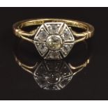 An 18ct gold ring set with a diamond surrounded by white sapphires, size M, 2.6g
