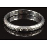 A platinum wedding band/ ring with engraved decoration, size L/M, 3.6g