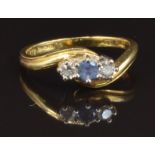 A 9ct gold ring set with a round cut sapphire and two diamonds, size M, 3.7g
