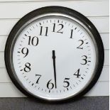 A large metal wall clock with black Arabic numerals, white dial and chrome bezel, 60cm in diameter