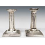 Victorian pair of hallmarked silver candlesticks with embossed swag decoration, London 1895 and