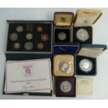 Four Royal Mint cased silver proof coins, a Festival of Britain crown and a 1984 deluxe cased set,