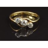 An 18ct gold ring set with three diamonds in a twist setting, size J, 2.4g