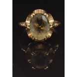 A 9ct gold ring set with an oval cut smoky quartz, size N, 3.4g