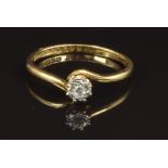 An 18ct gold ring set with a diamond in a platinum star setting, size R, 2.6g