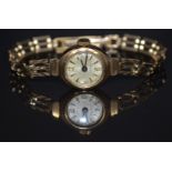 Unnamed 9ct gold ladies wristwatch with blued hands, gold Arabic numerals and hour markers, silver
