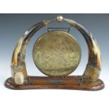 Dinner gong flanked by horns, width 37cm