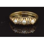 An 18ct gold ring set with diamonds and pearls, Birmingham 1914, size M, 3.3g