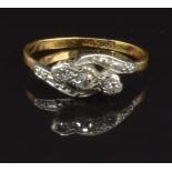 An 18ct gold ring set with three diamonds in a platinum setting, size L, 2.3g