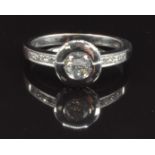 An 18ct white gold ring set with a round cut diamond of approximately 0.4ct and with diamond set