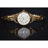 Tudor 9ct gold ladies wristwatch with inset subsidiary seconds dial, gold hands and Arabic numerals,