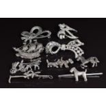 Four silver brooches set with marcasite, a silver brooch in the form of an Airedale dog and other