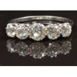 An 18ct white gold ring set with five old cut diamonds, the centre stone approximately 0.5ct, in