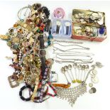 A collection of costume and silver jewellery including chains, beads, silver spoons, Ronson