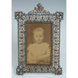Gilt metal photograph frame set with garnets, opals and turquoise stones c1900, in the Russian or