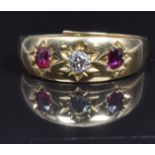An 18ct gold ring set with a diamond and rubies, 2.5g