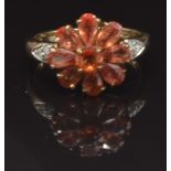 A 9ct gold ring set with garnets and diamonds in a flower cluster, size M, 3.5g