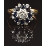 An 18ct gold ring set with diamonds and sapphires in a cluster, size M, 5.4g