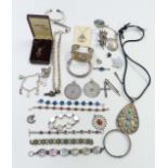 A collection of silver jewellery including pendants, bracelets, brooches, etc