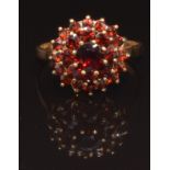 A 9ct gold ring set with a cluster of garnets, size Q, 2.9g