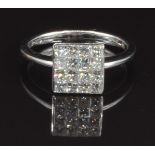 An 18ct white gold ring set with approximately 0.75ct of square cut diamonds, size N, 3.6g