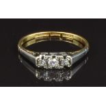 An 18ct gold ring set with three round cut diamonds in a platinum setting, size O, 2g