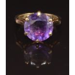 A 9ct gold ring set with a round cut amethyst, 4.1g
