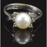 An 18ct white gold ring set with a pearl and diamonds, size K, 2.1g