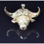 An 18ct gold pendant in the form of a Cape buffalo set with diamond eyes, by Franz Hirner, 4 x