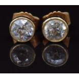 A pair of 18ct gold earrings each set with a diamond of approximately 0.5ct