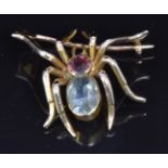 A c1900 gold brooch in the form of a spider set with an oval aquamarine and a round cut topaz, 2 x
