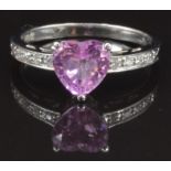 A 14k white gold ring set with a pink heart cut sapphire and diamonds, size M, 2.8g