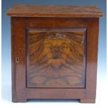 A walnut collector's cabinet with two over four straight drawers behind a door, W29 x D20 x H29cm