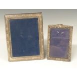 Two hallmarked silver photograph frames the larger to suit 7 x 5 inch photo, both with easel backs