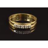 An 18ct gold ring set with five diamonds, size N, 2.4g