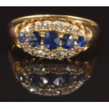 An 18ct gold ring set with oval cut sapphires and diamonds, Birmingham 1909, size M, 3.1g