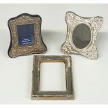 Three various hallmarked silver photograph frames, two having embossed decoration and easel backs,