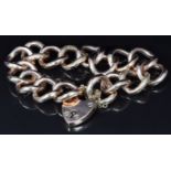 A 9ct rose gold curb link bracelet made up of alternating engraved and smooth links, 29g