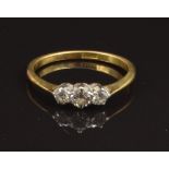 An 18ct gold ring set with three diamonds, size K, 2g