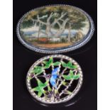 A silver brooch set with a painted ivory plaque and a silver brooch set with enamel