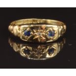 An 18ct gold ring set with a diamond and two sapphires in star setting, Birmingham 1916, size M, 1.