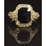 An 18ct gold ring set with an emerald cut sapphire and diamonds, size O, 3.9g