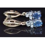 A pair of 9ct gold earrings set with an oval sapphire and diamonds, 2.8g
