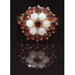 A 9ct gold ring set with garnets and opals in a cluster, size M, 4.8g