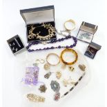 A collection of jewellery including brooches, amethyst necklace, filigree ring, silver bracelet, etc