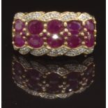 A 9ct gold ring set with oval cut rubies and diamonds, size O, 4.2g