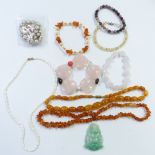 A collection of necklaces including two amber, pearl and rose quartz, Chinese quartz pendant, etc