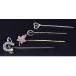 Victorian silver stick pin in the form of a horseshoe and riding crop, a 9ct gold stick pin set with