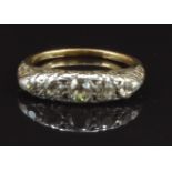 Victorian 18ct gold ring set with five old cut diamonds in a scrolling setting, the centre diamond