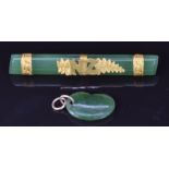 A 9ct gold and jade brooch with NZ for New Zealand and a jadeite kidney bean charm/ pendant
